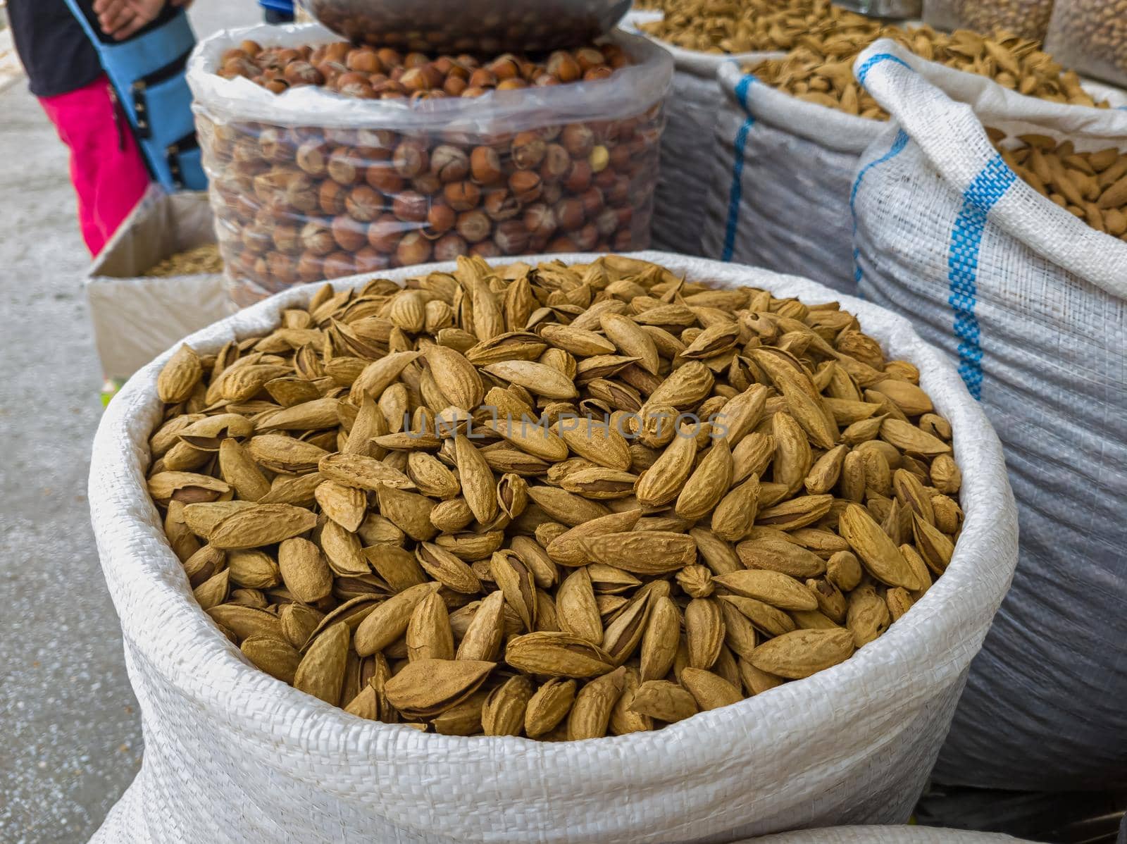 Oriental Bazaar. Almond peeled and unpeeled, nuts sales in market. Dry food, variety almonds in store. Concept of healthy eating, raw product, bazaar, diet, almond theme.