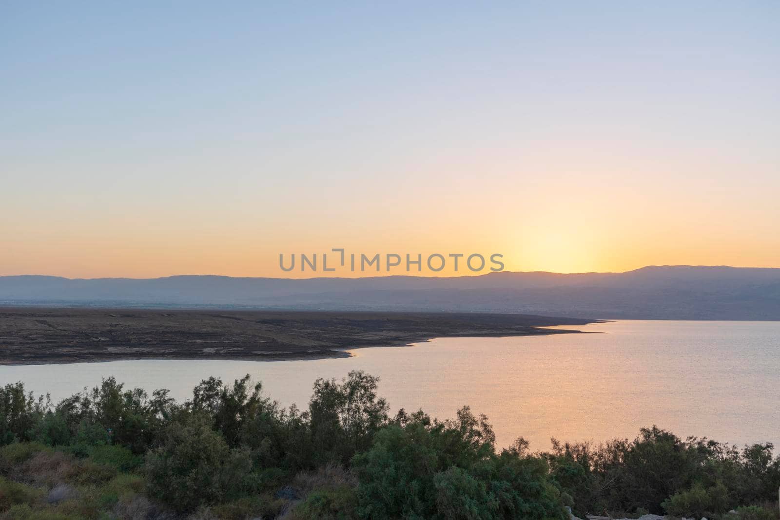 Orange sunrise reflecting off of the Dead Sea. High quality photo