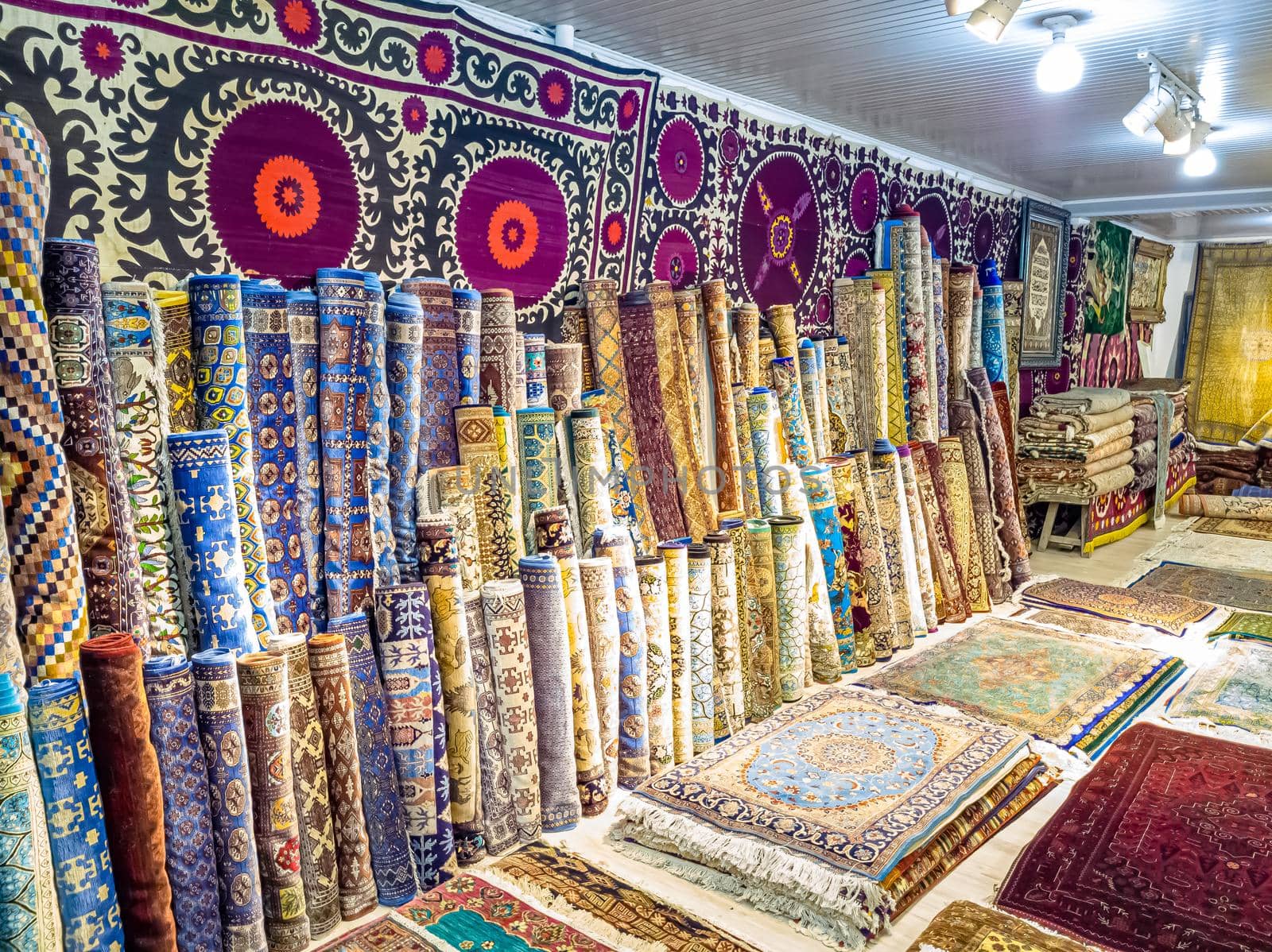 Ethnic carpet, ornamental folk bags, many ornate pillows with embroidery in asian shop, store. Asian market, trade fair in Uzbekistan. Traditional national ornament. Asian handicraft, Uzbek craft by Milanchikov