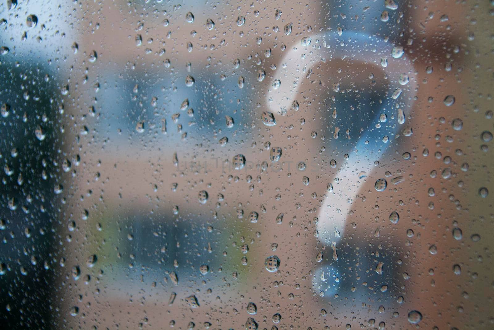 raindrops on the window and question mark - concept photo. High quality photo