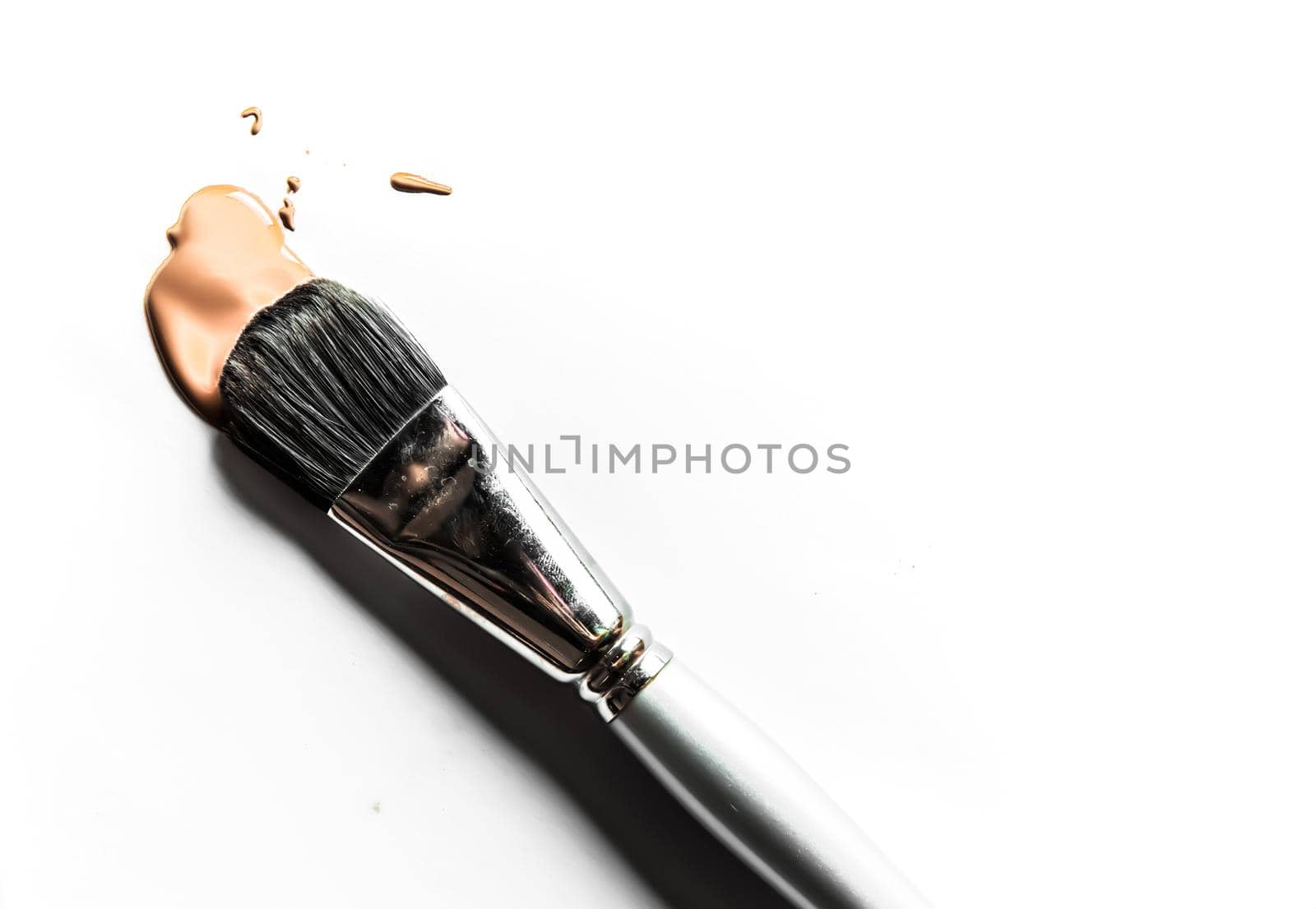 Beauty texture, cosmetic product and art of make-up concept - Brush and liquid foundation close-up isolated on white background