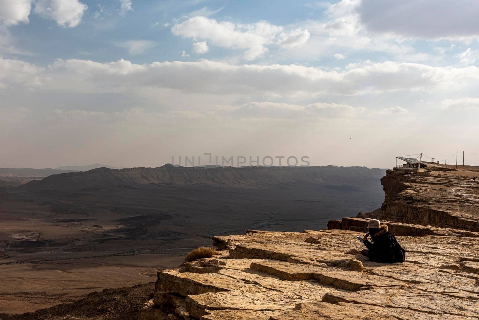 Ramon Crater Makhtesh Ramon, the largest in the world, as seen from the high rocky cliff edge surrounding it from the north, Ramon Nature reserve, Mitzpe Ramon, Negev desert, Israel. High quality photo