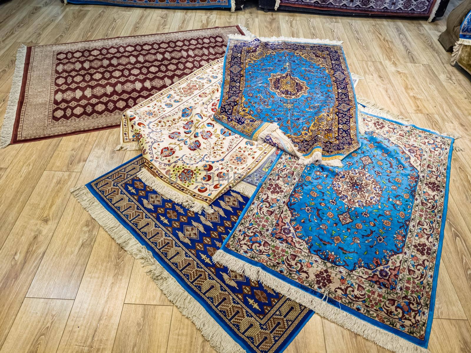 Ethnic carpet, ornamental folk bags, many ornate pillows with embroidery in asian shop, store. Asian market, trade fair in Uzbekistan. Traditional national ornament. Asian handicraft, Uzbek craft by Milanchikov