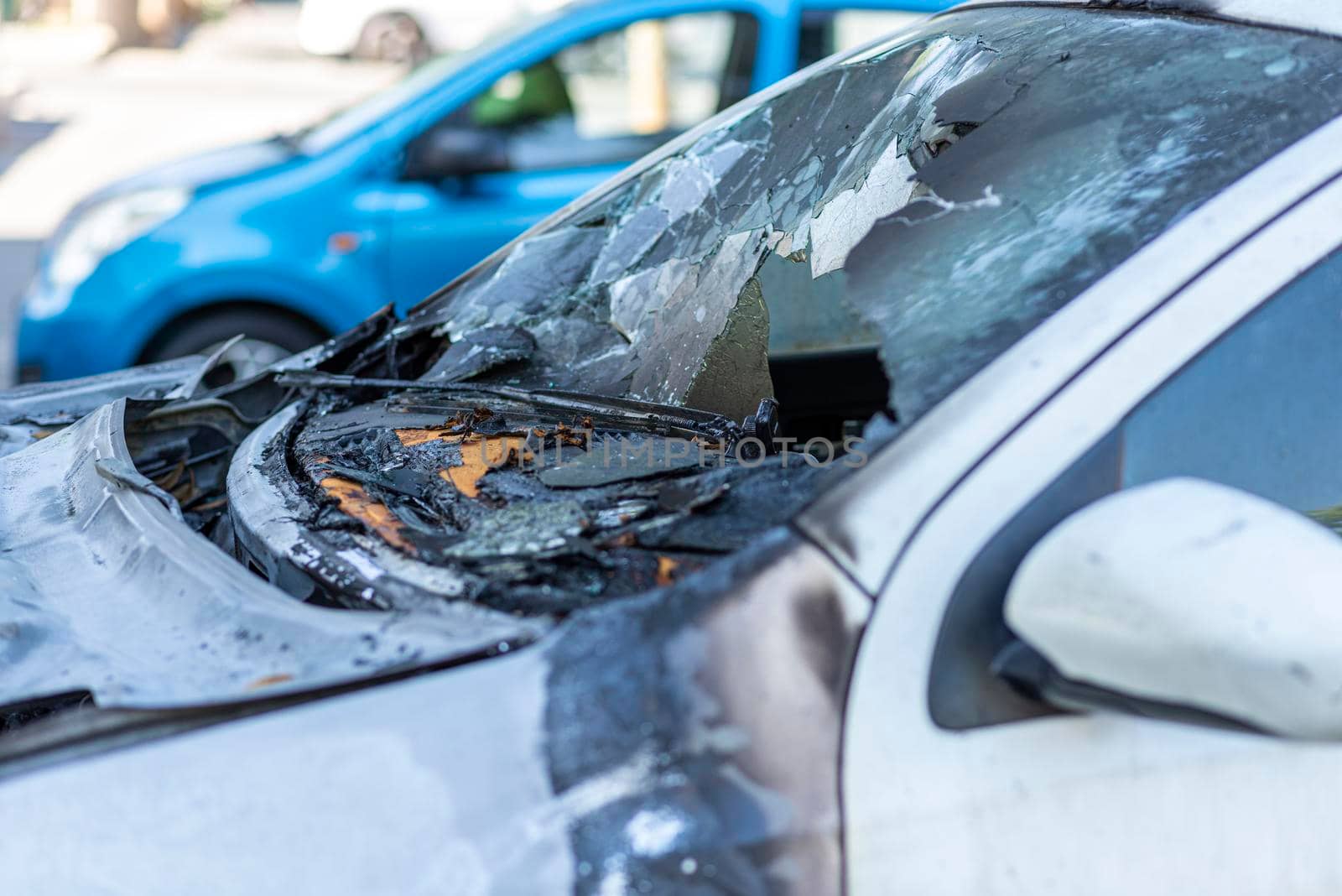 Burned car close up. Car after the fire, crime of vandalism, riots. Arson car. Accident on the road due to speeding. Explosion. High quality photo