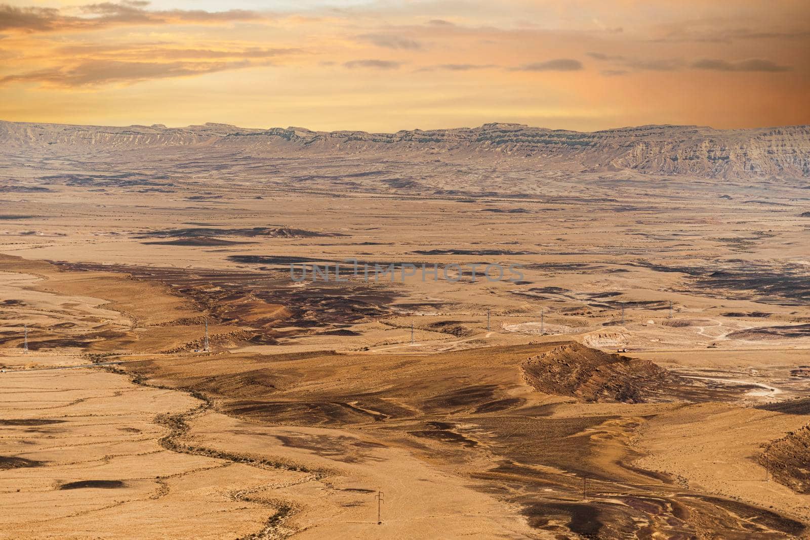 Ramon Crater Makhtesh Ramon, the largest in the world, as seen from the high rocky cliff edge surrounding it from the north, Ramon Nature reserve, Mitzpe Ramon, Negev desert, Israel. High quality photo