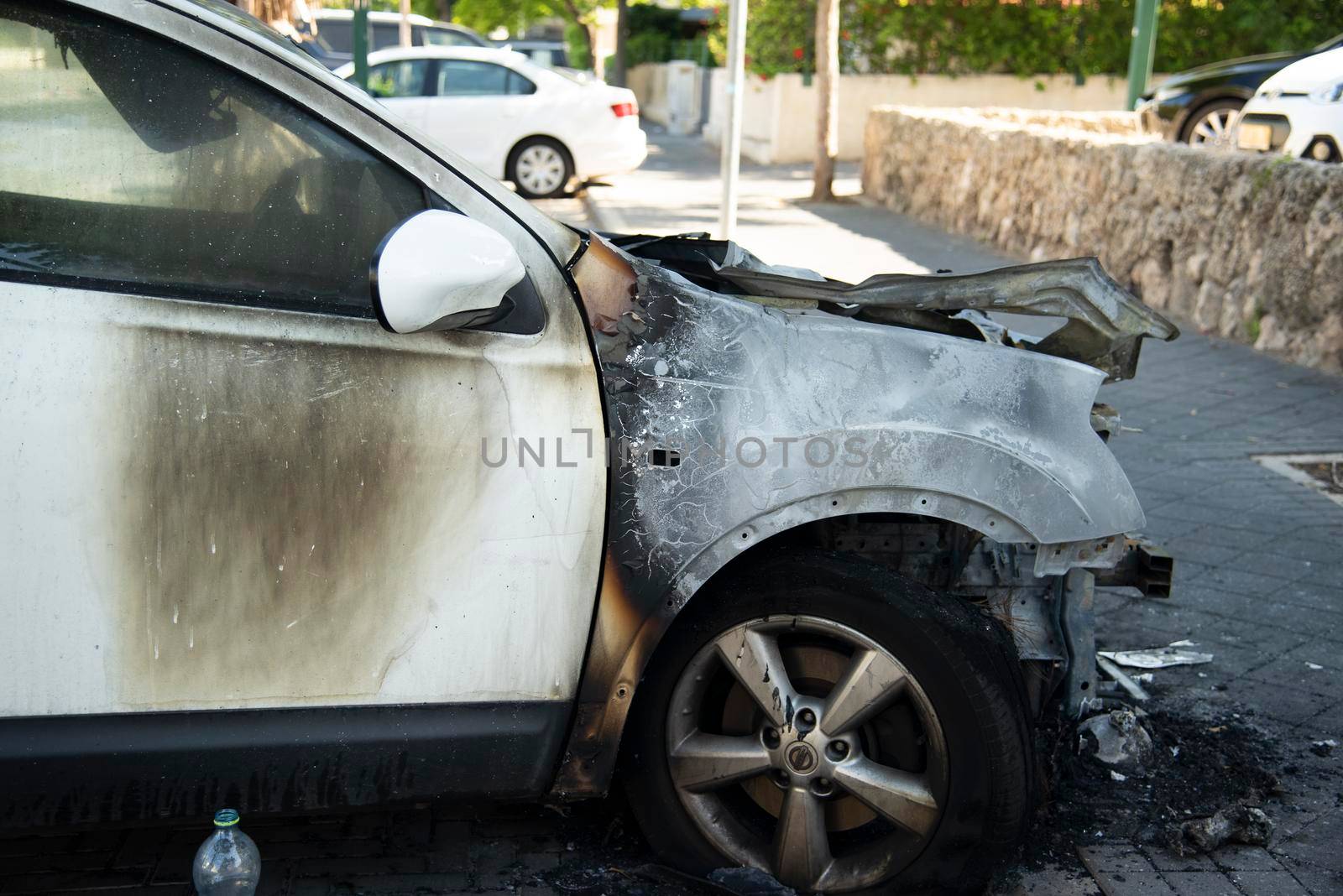 ISRAEL, Tel Aviv - 15 May 2021: Vandalism or revenge, burnt car. The consequences of popular protest, burnt car, a crime. Car after fire. Auto trash by avirozen