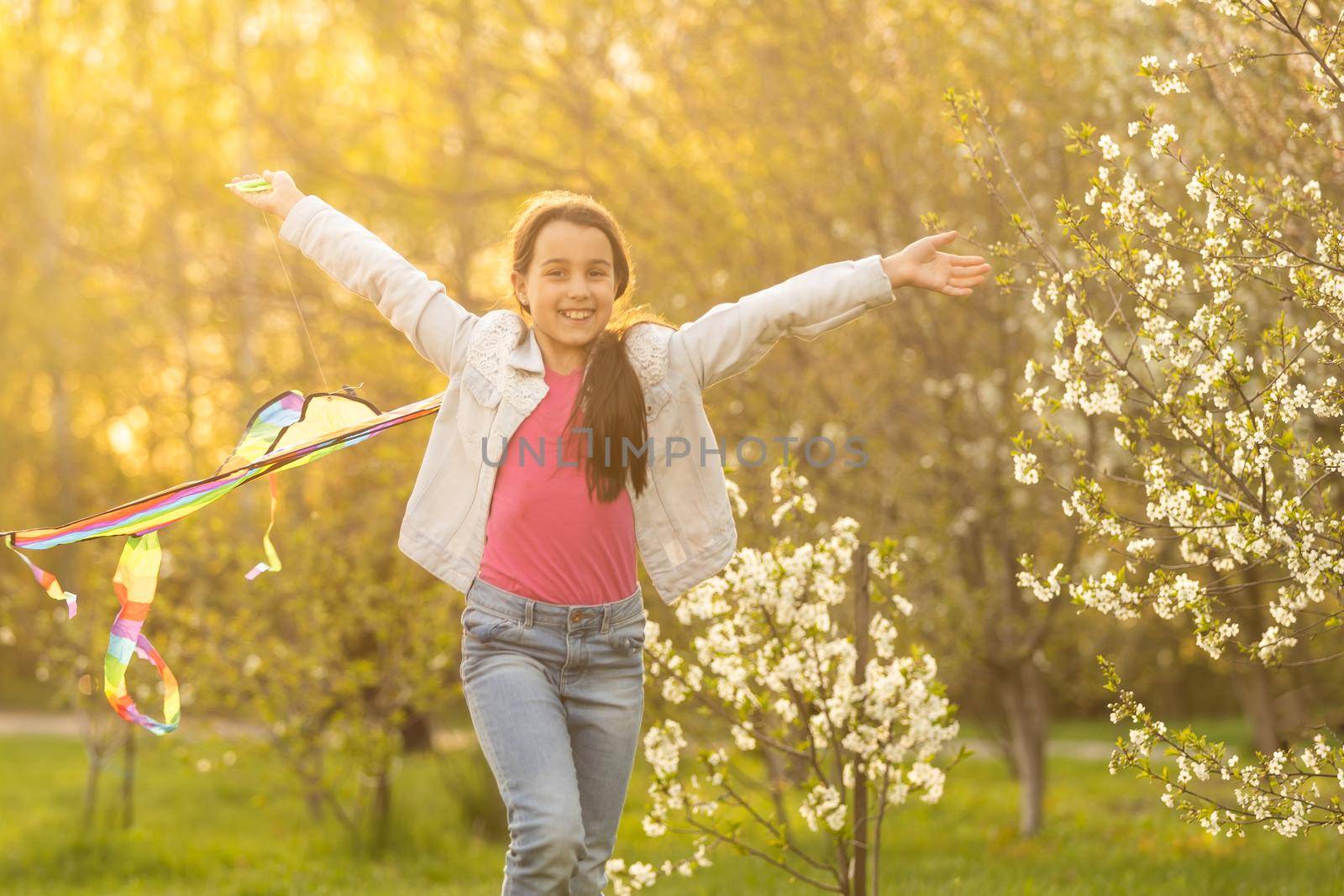 little girl with a kite in the spring