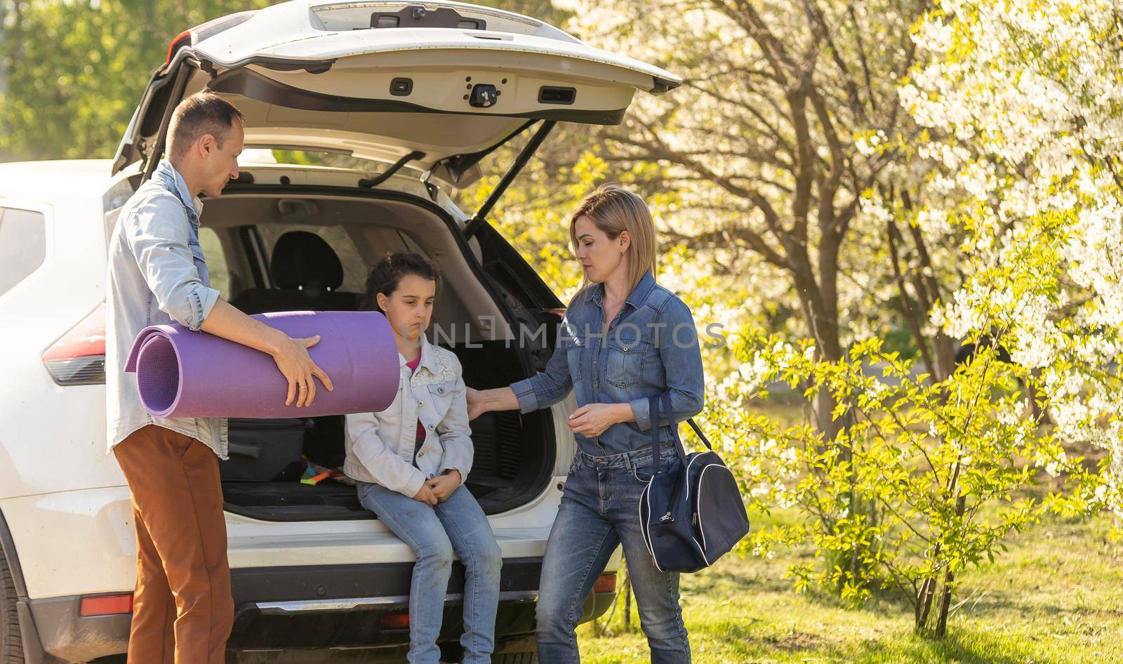 Happy family ready to go for a ride on their car