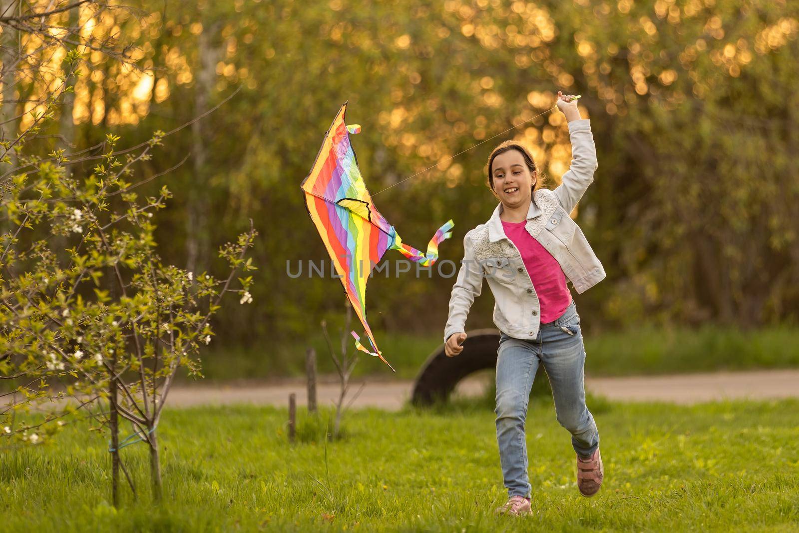 little girl with a kite in the spring
