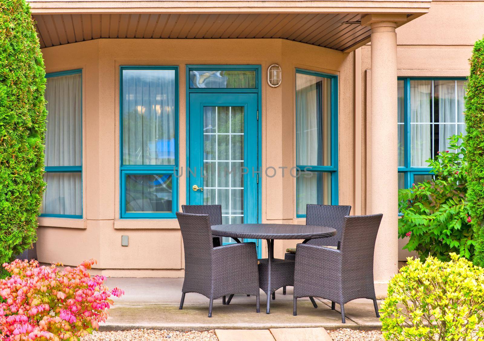 Outdoor table with four chairs on residential patio.