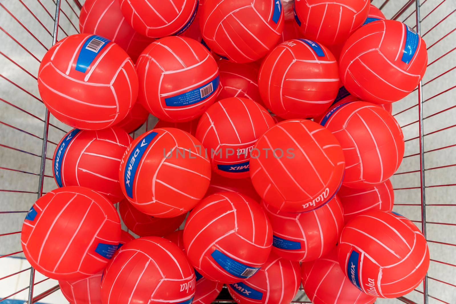 SAINT PETERSBURG, RUSSIA - AUGUST 14, 2022: new volleyball and soccer balls in the basket of a sporting goods store. colorful sports equipment in the sports store