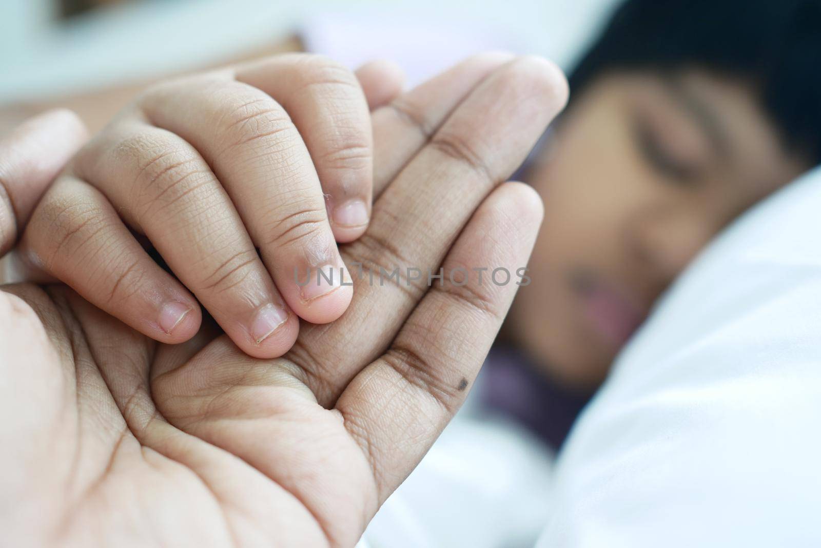 father holding his child hand close up .