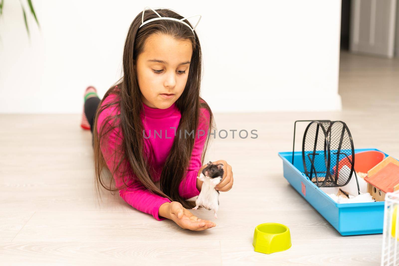 little girl holding a hamster
