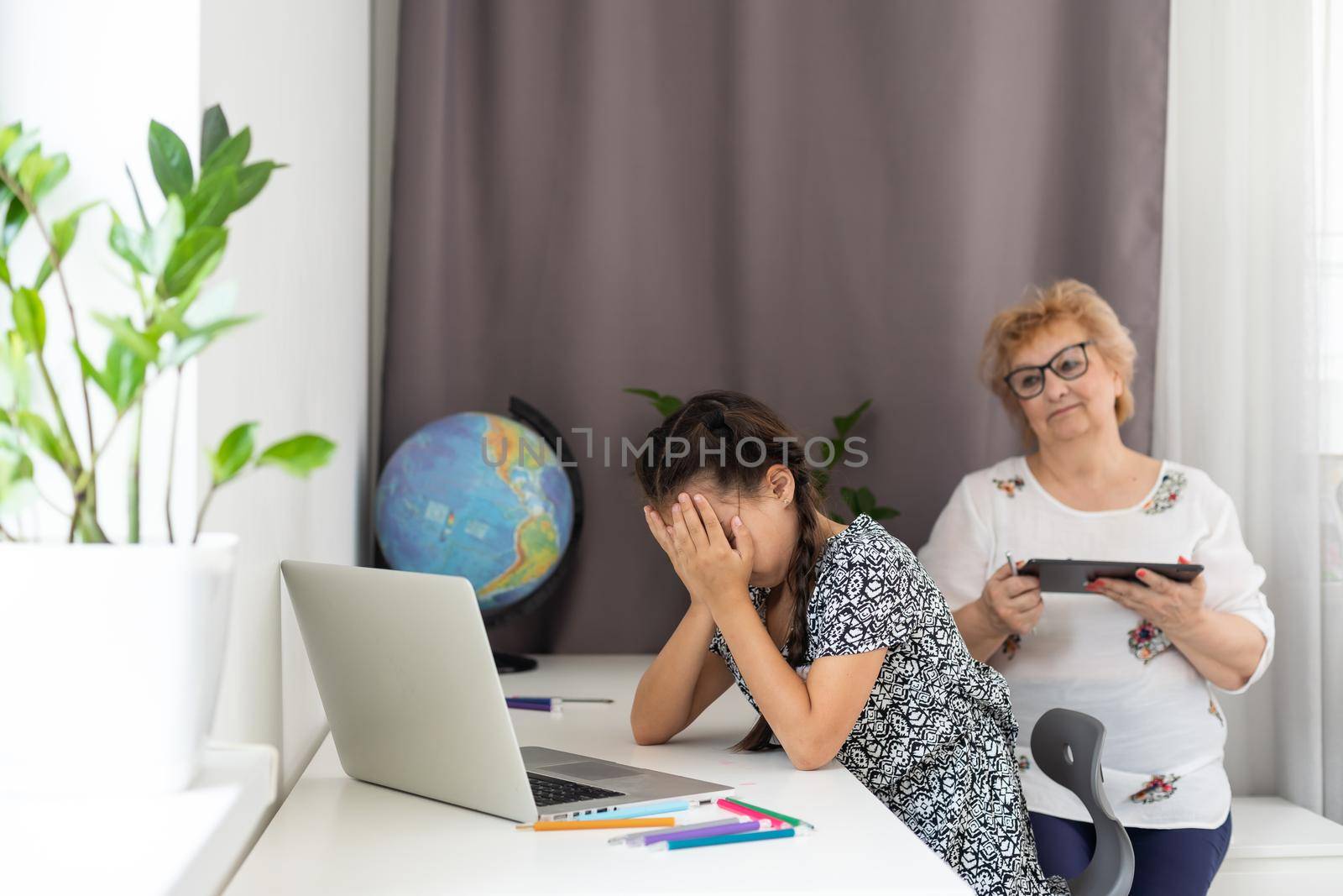little sad girl and grandmother argue at home.