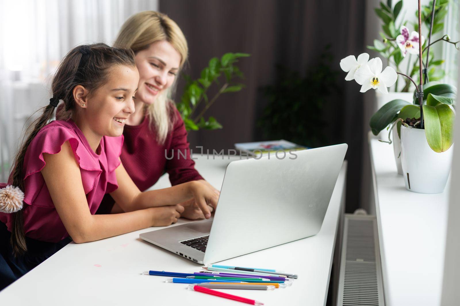 Cute little girl with therapist. Young woman teacher and child on private lesson