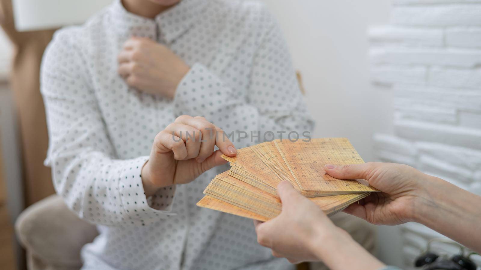 Psychologist uses metaphorical associative cards in a session with a patient. Close up