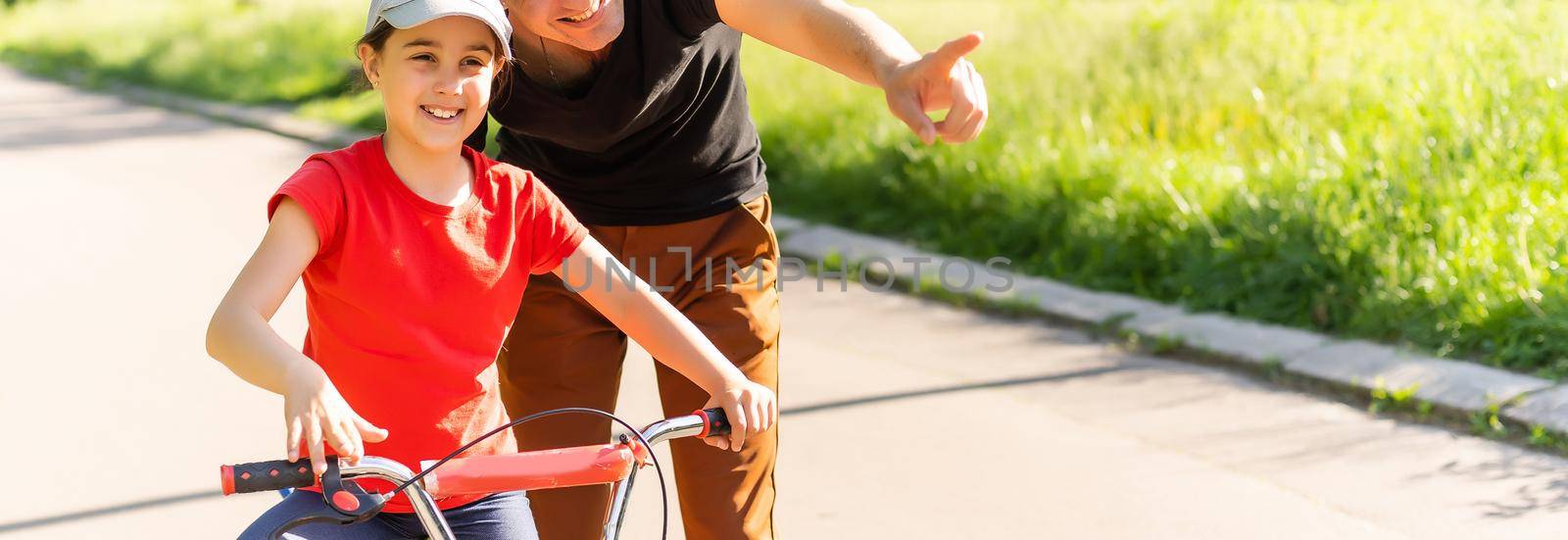 Girl learning to ride bike.