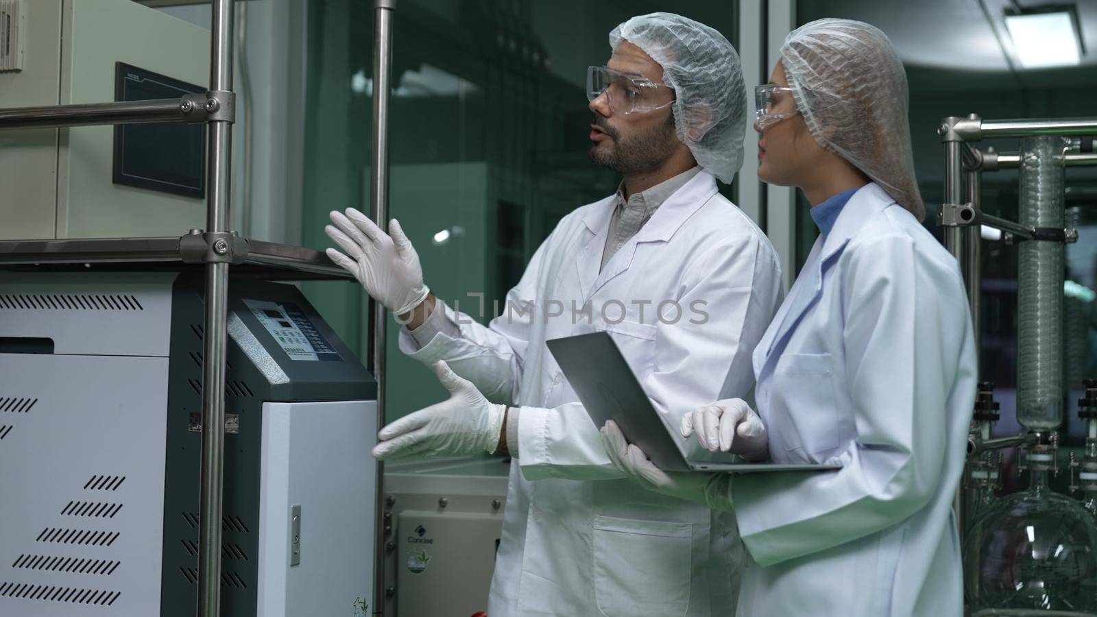 Two scientist in professional uniform working in laboratory for chemical and biomedical experiment