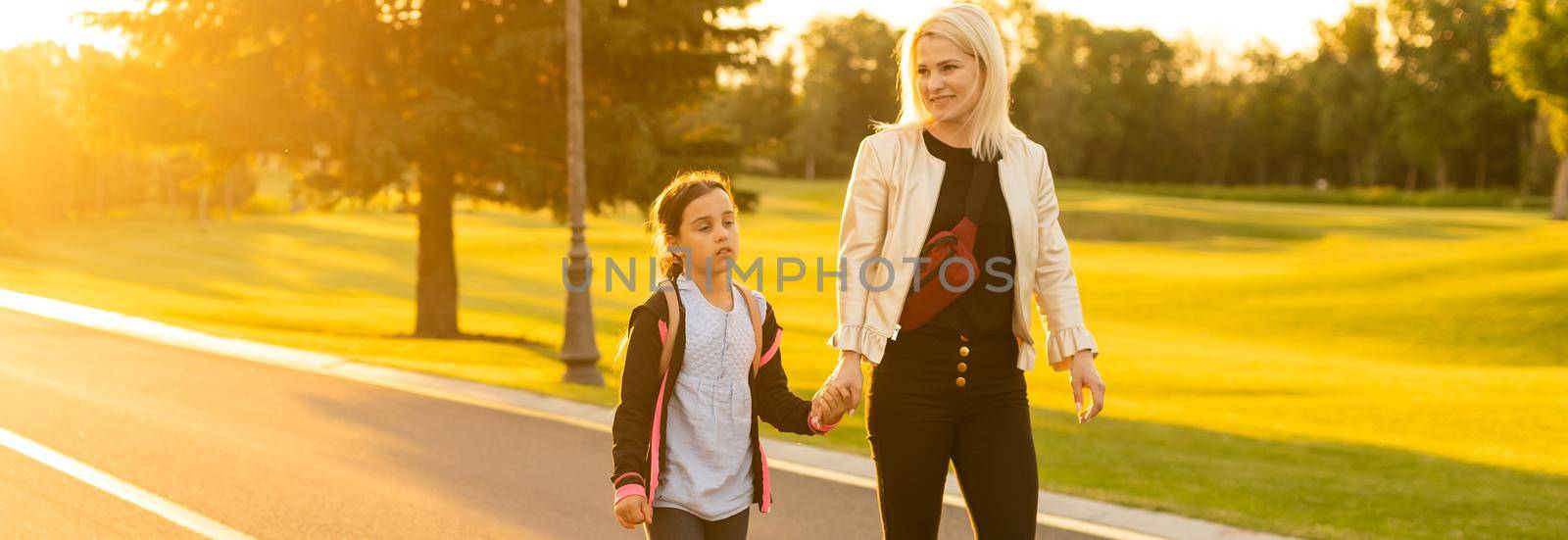 Mother taking daughter to school.