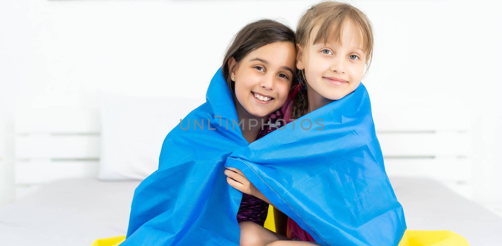 children carry fluttering flag of Ukraine. Ukraine's Independence Day. Flag Day. Constitution day. Girls with flag of Ukraine by Andelov13