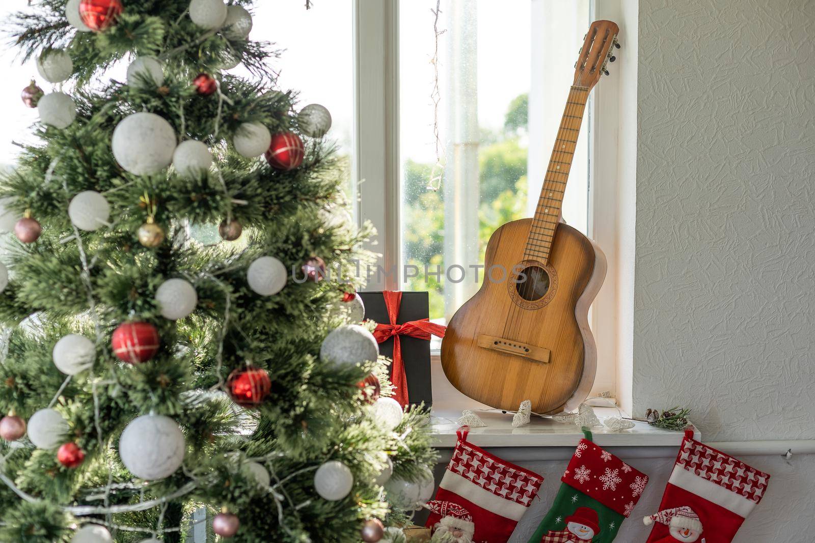 Flat lay composition with guitar and Santa hat, space for text. Christmas music by Andelov13