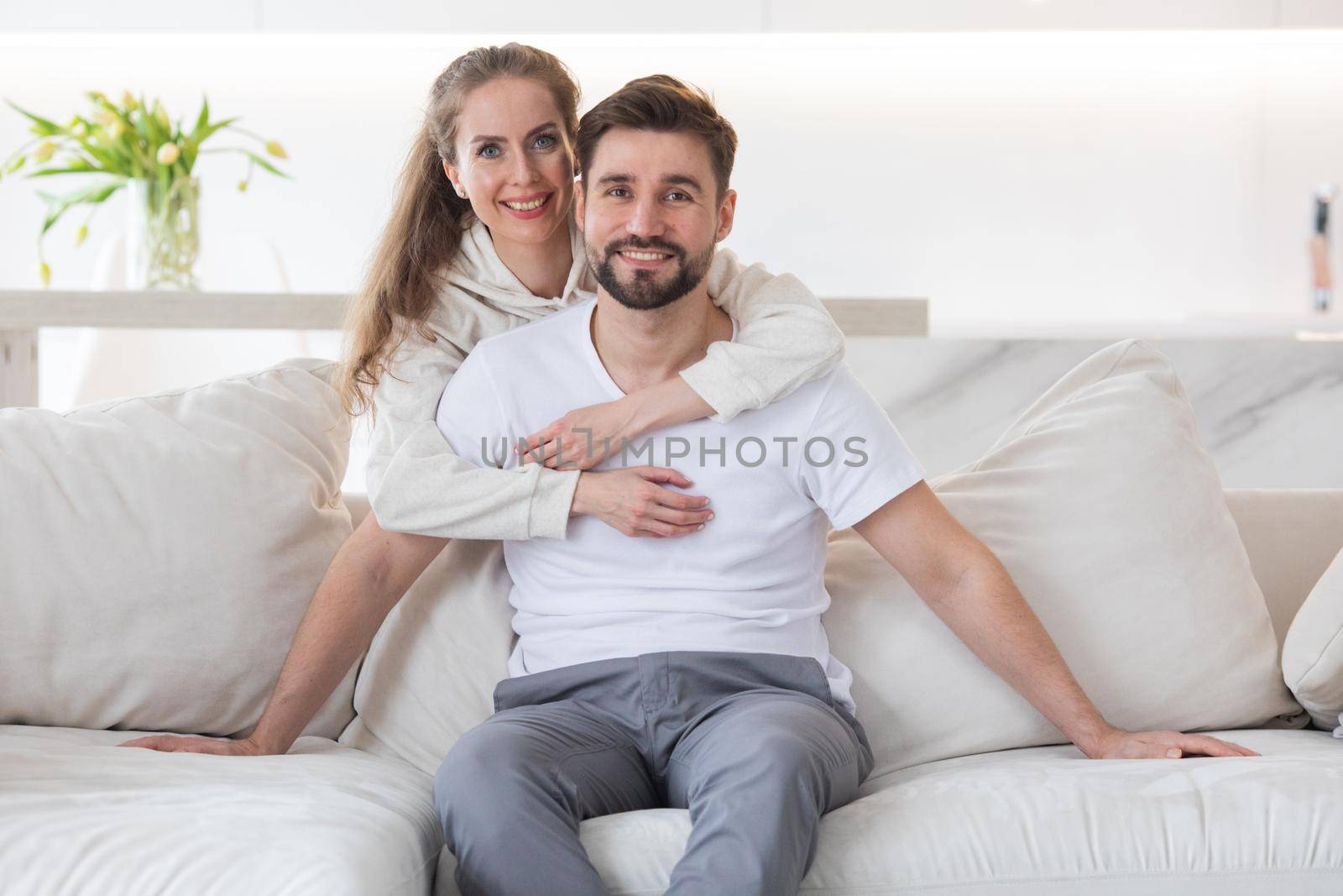 Couple relaxing in living room by ALotOfPeople