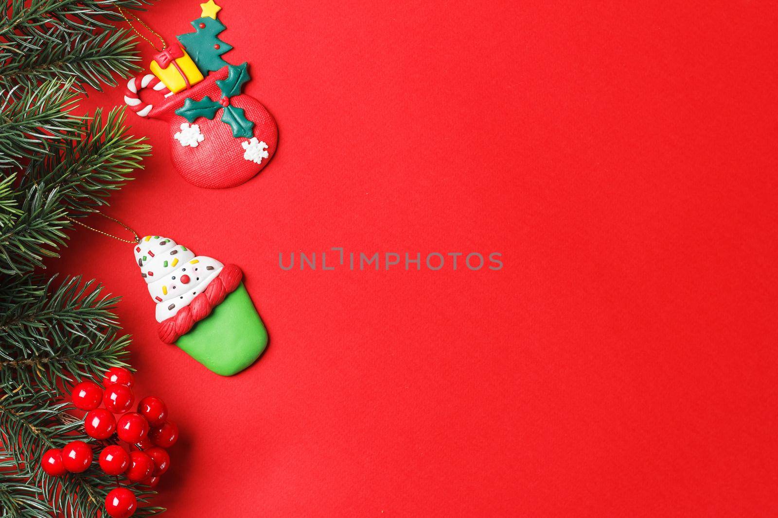 Christmas red background of fir branches and toys. copy space