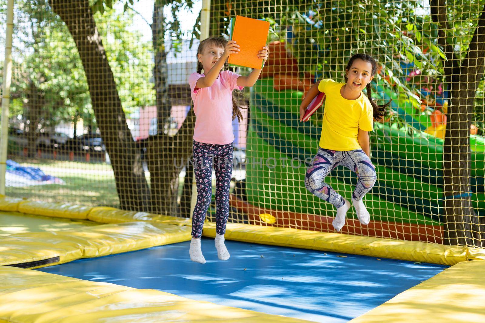 Happy children jumping on trampoline.