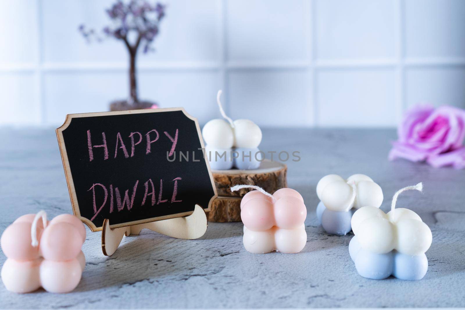 small bubble candles and blackboard with happy diwali written in chalk perfect card for diwali wishes by Shalinimathur