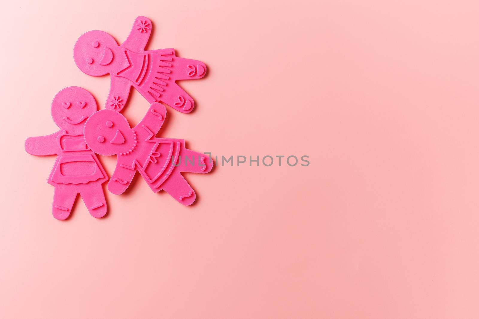 Preparing for Christmas. Pink cookie cutters isolated on a pink background. copy space
