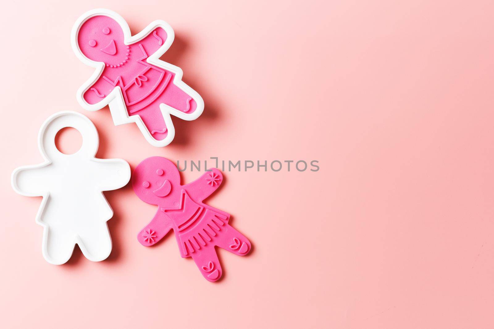 Preparing for Christmas. Pink cookie cutters isolated on a pink background. copy space by lara29