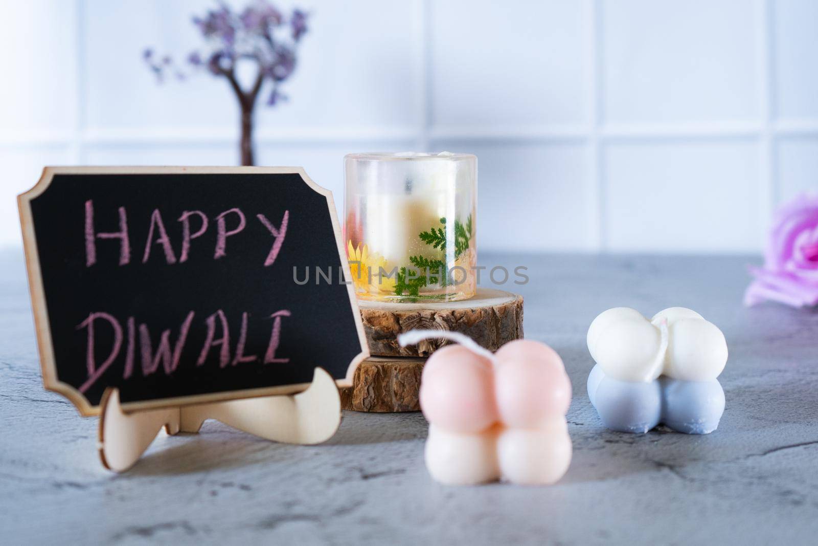 small bubble candles and blackboard with happy diwali written in chalk perfect card for diwali wishes in India