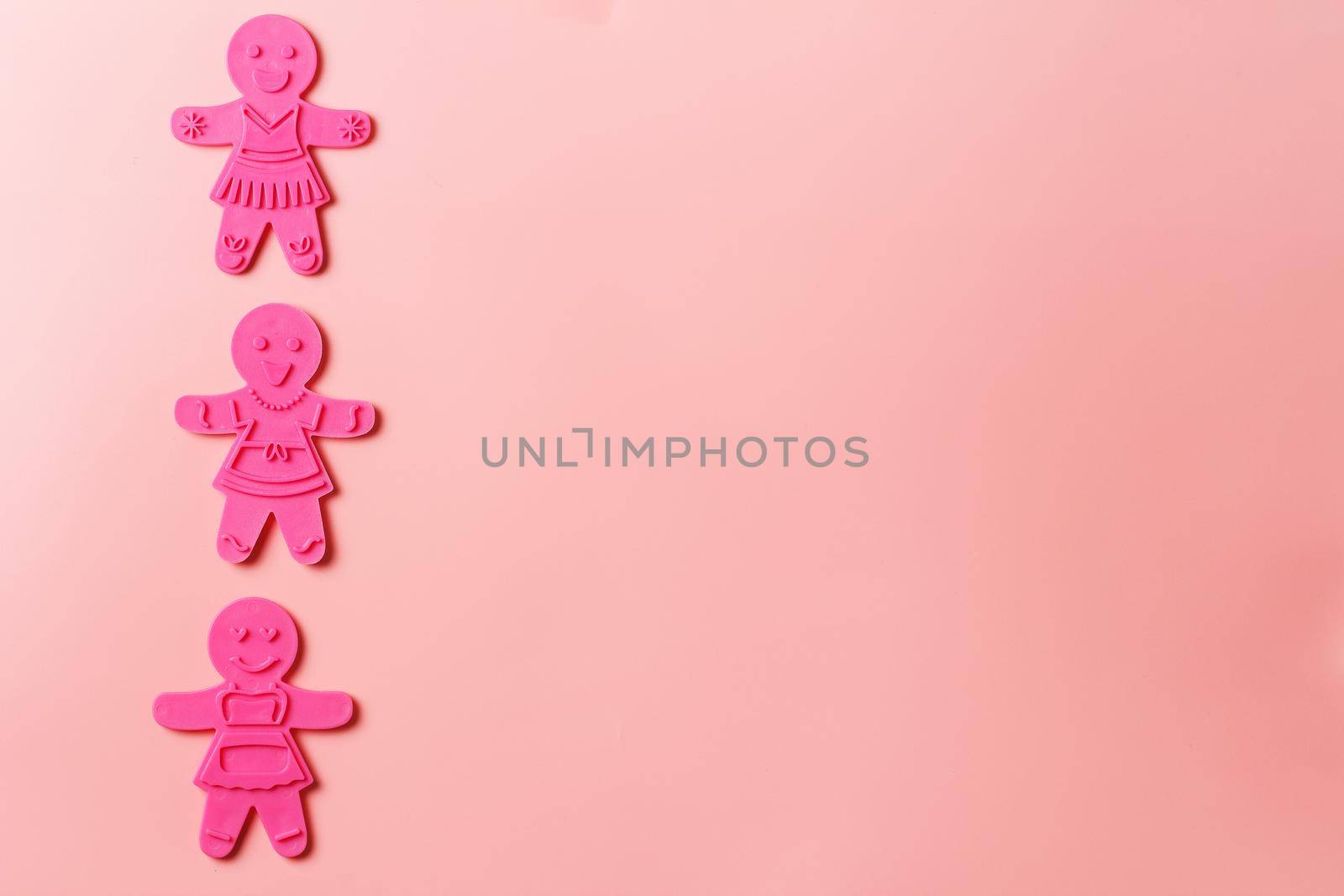 Preparing for Christmas. Pink cookie cutters isolated on a pink background. copy space by lara29