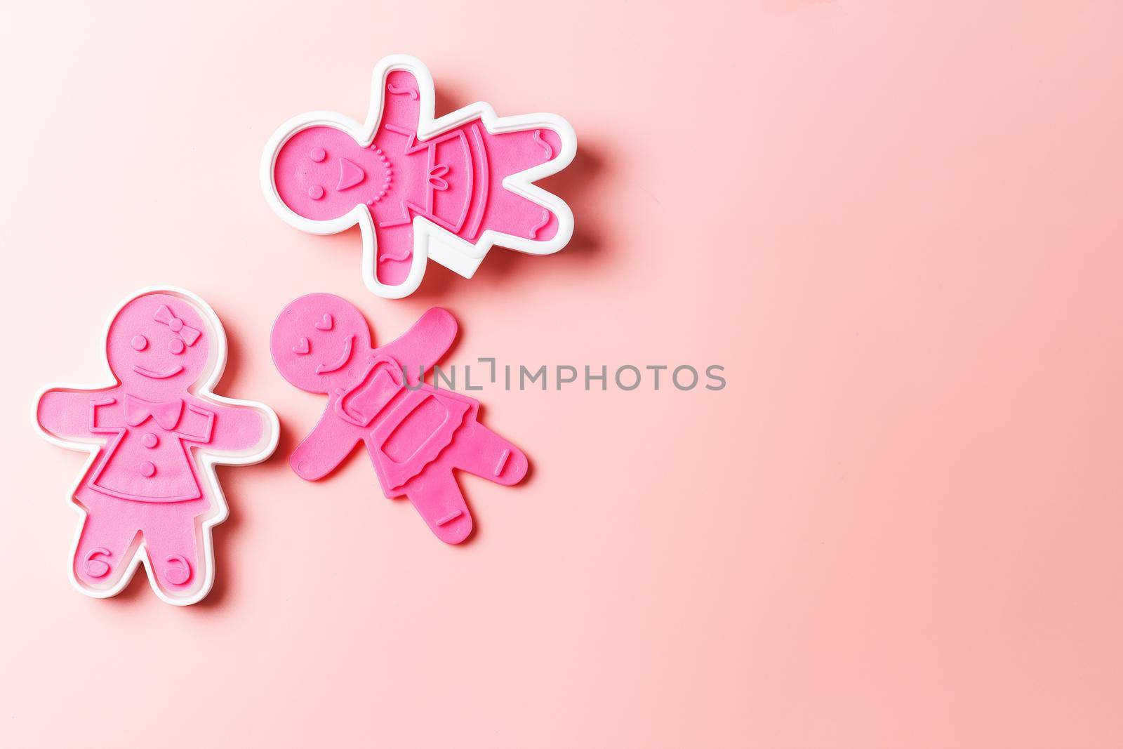 Preparing for Christmas. Pink cookie cutters isolated on a pink background. copy space by lara29
