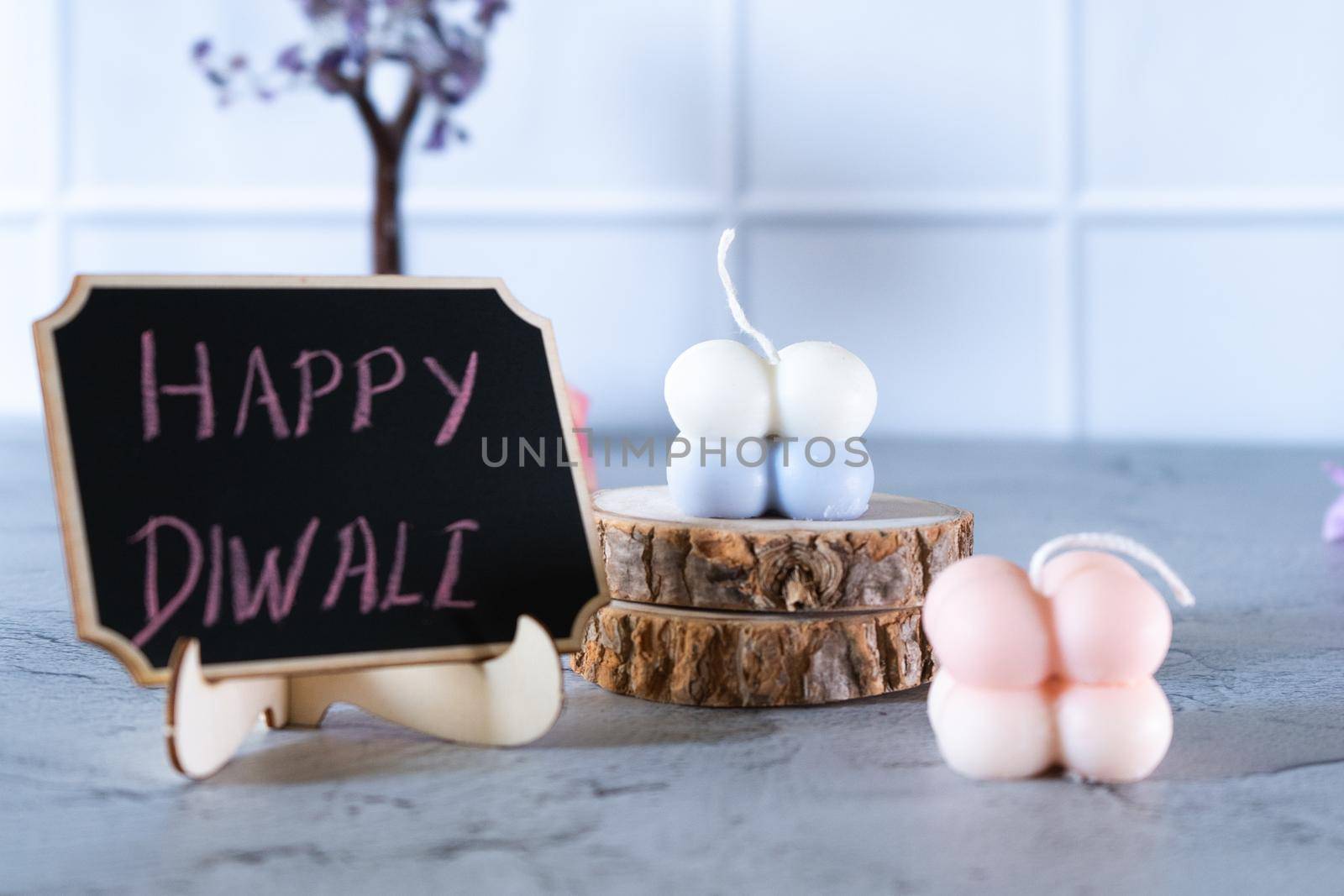 small bubble candles and blackboard with happy diwali written in chalk perfect card for diwali wishes by Shalinimathur