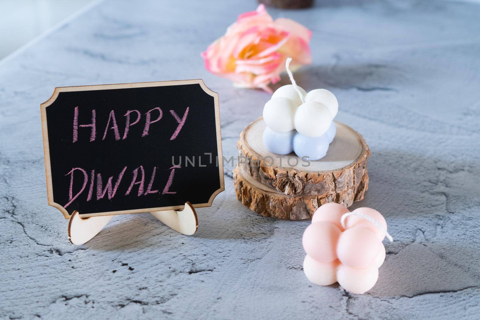 small bubble candles and blackboard with happy diwali written in chalk perfect card for diwali wishes in India