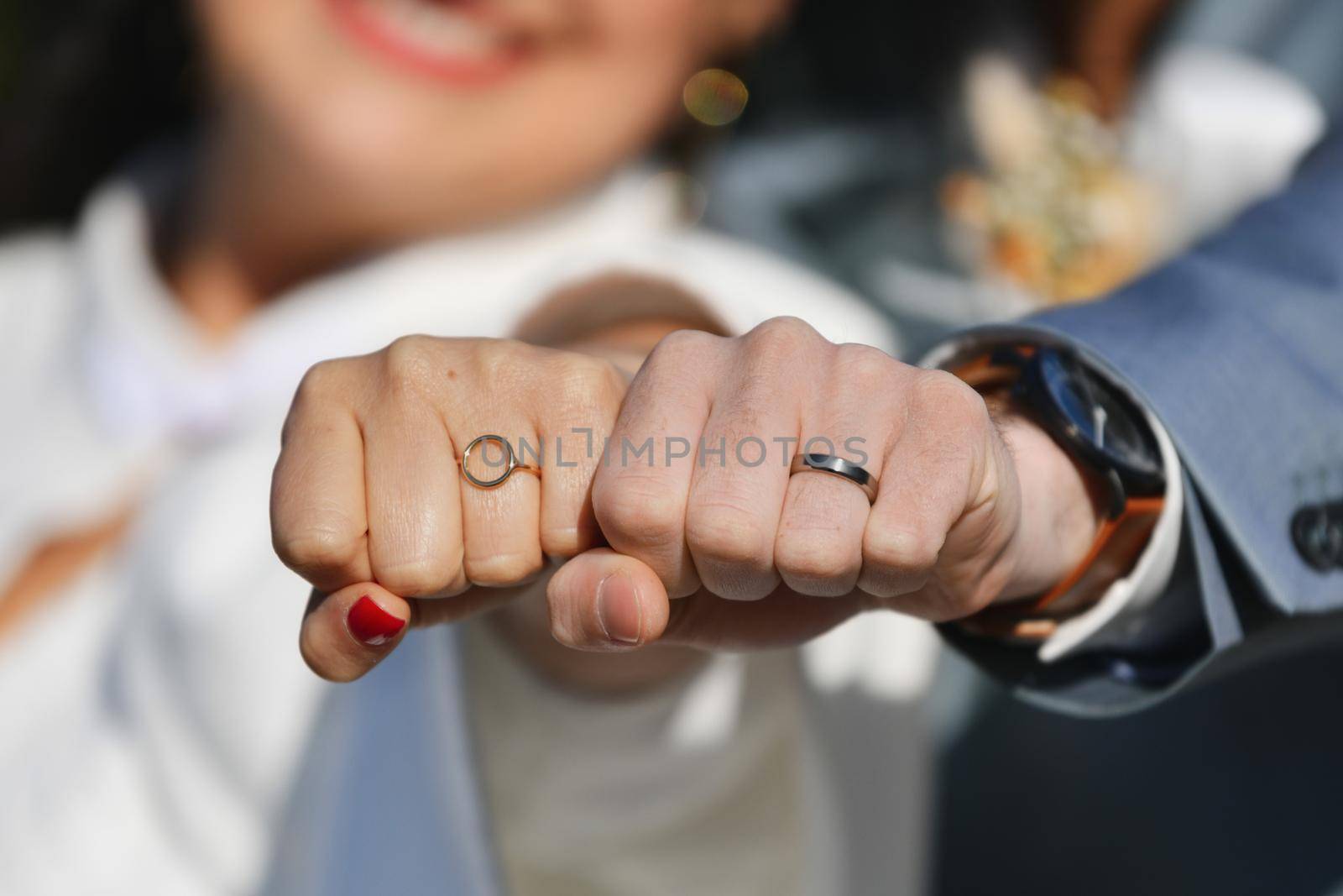 Newlyweds show wedding rings to the camera