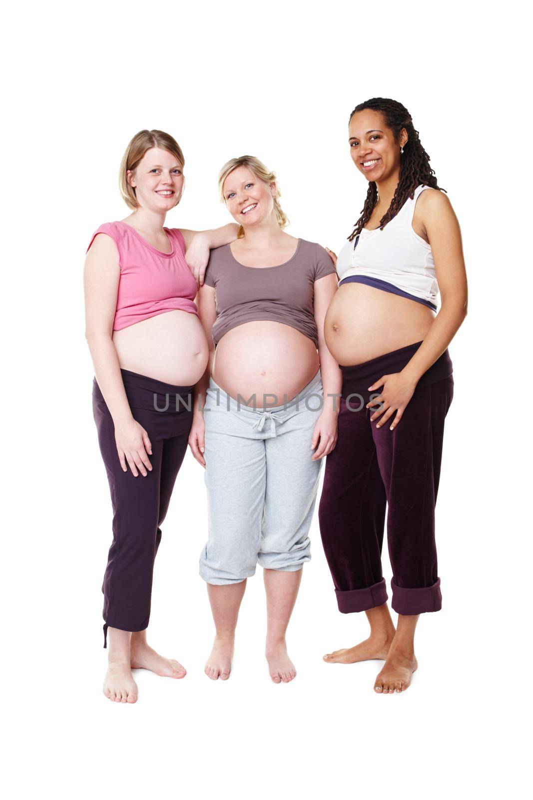 Pregnant, happy and diversity women pregnancy portrait, mother to be with wellness success smile with white background in studio. Support, maternity and friends with pilates, health or yoga clothes by YuriArcurs