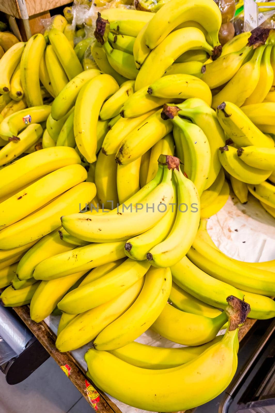 Yellow bananas are on the shelf of the store.