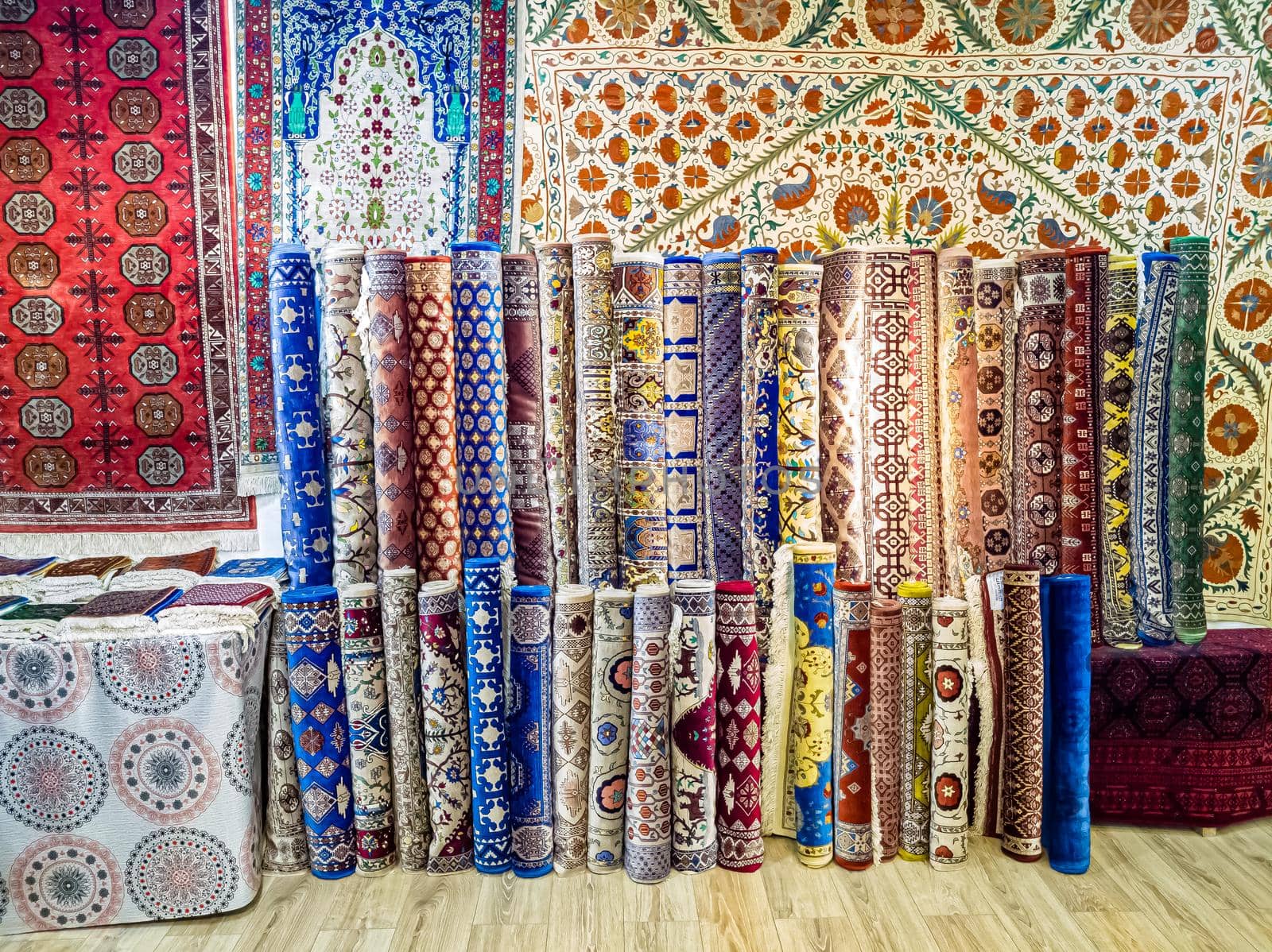 Ethnic carpet, ornamental folk bags, many ornate pillows with embroidery in asian shop, store. Asian market, trade fair in Uzbekistan. Traditional national ornament. Asian handicraft, Uzbek craft.
