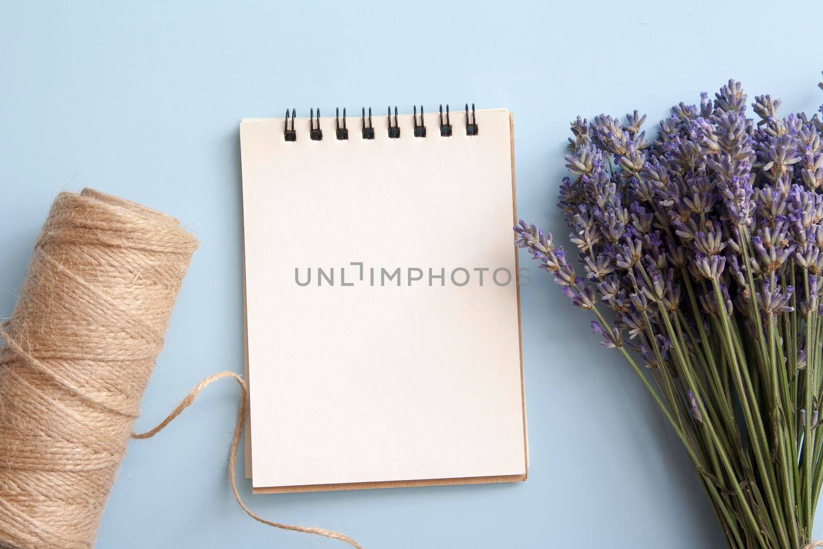 Blank sheet of flat lay notebook with lavender, twine. Write your message. High quality photo