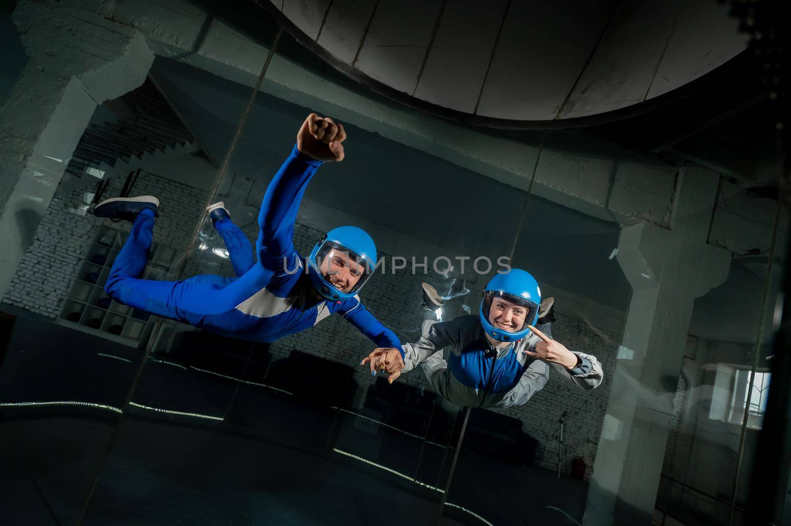 A man and a woman enjoy flying together in a wind tunnel. Free fall simulator by mrwed54