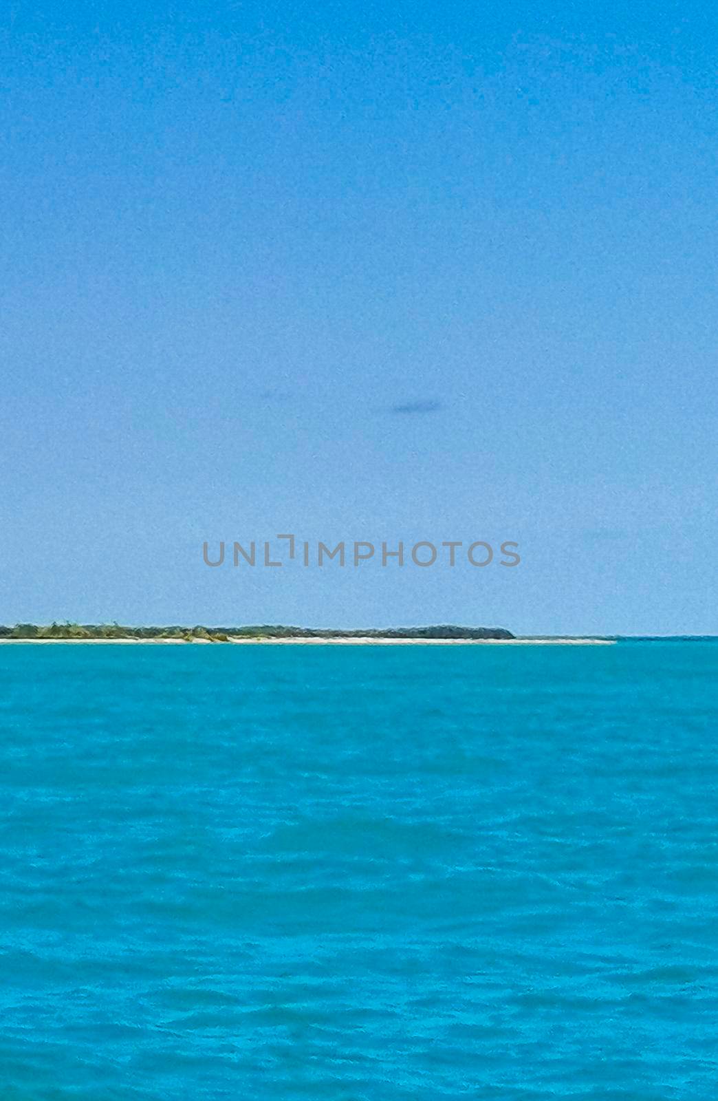 Boat trip tour from Cancun to Island Mujeres Isla Contoy and Whale shark tour with natural tropical seascape panorama and blue turquoise and green clear water view from boat in Quintana Roo Mexico.