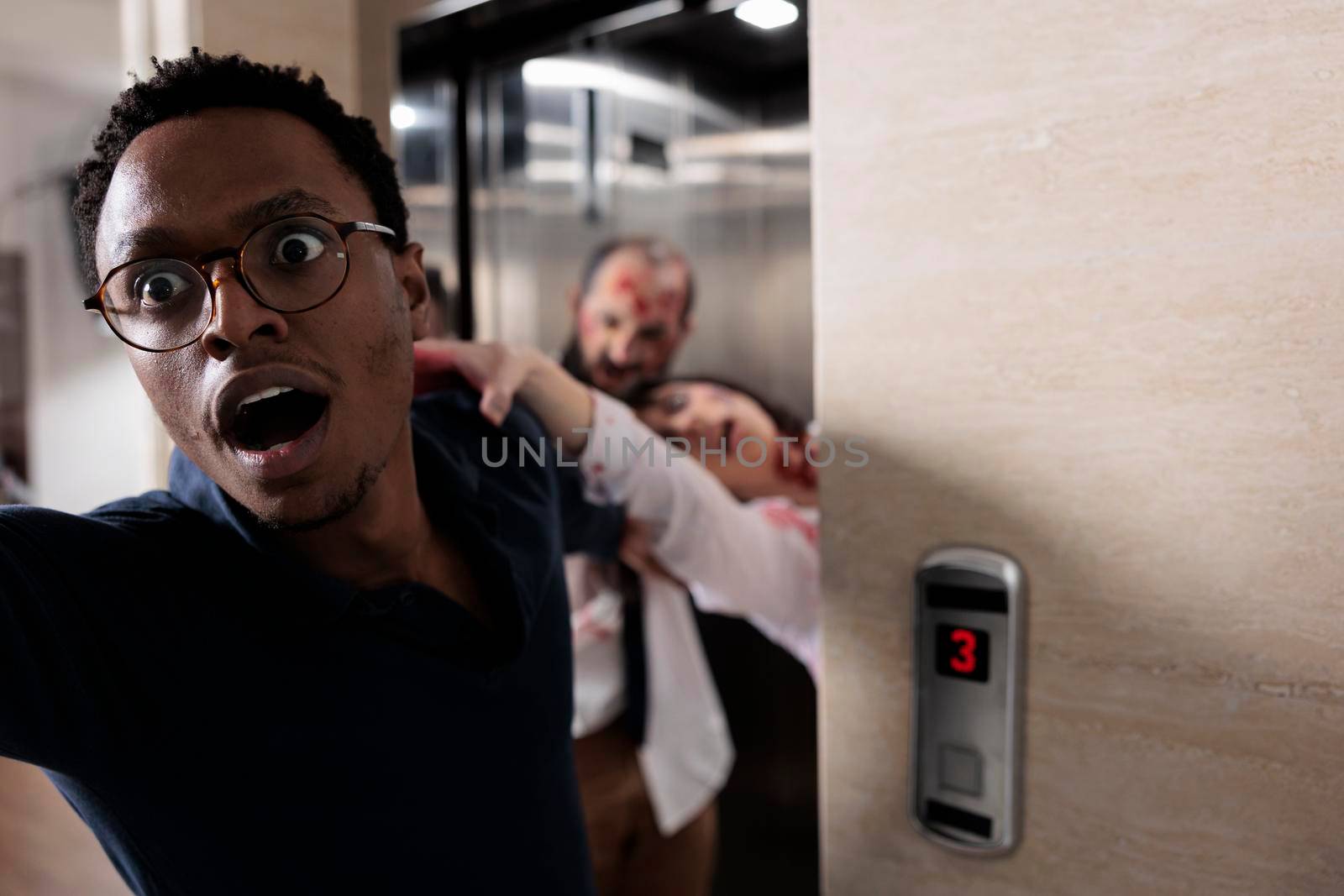 Frightened man running from evil zombies, trying to escape elevator from terrifying scary walkers. Brain eating monsters chasing and grabbing person, undead creepy walking dead corpses.