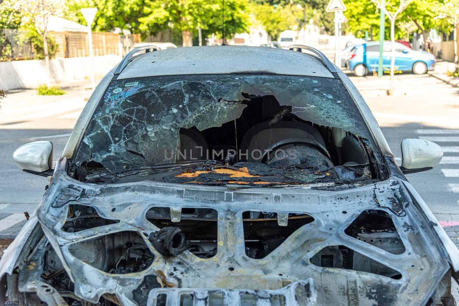ISRAEL, Tel Aviv - 15 May 2021: Vandalism or revenge, burnt car. The consequences of popular protest, burnt car, a crime. Car after fire. Auto trash. High quality photo