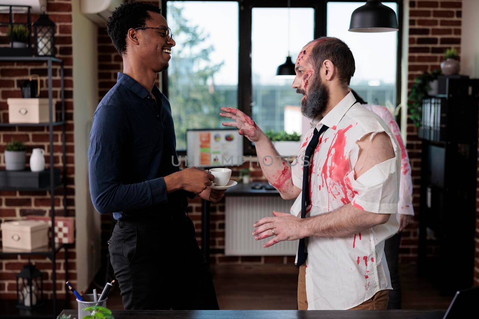 Spooky zombie talking to person in office, bloodthirsty brain eating monster having conversation in business workplace. Walking dead corpse with bloody wounds and sinister scars.