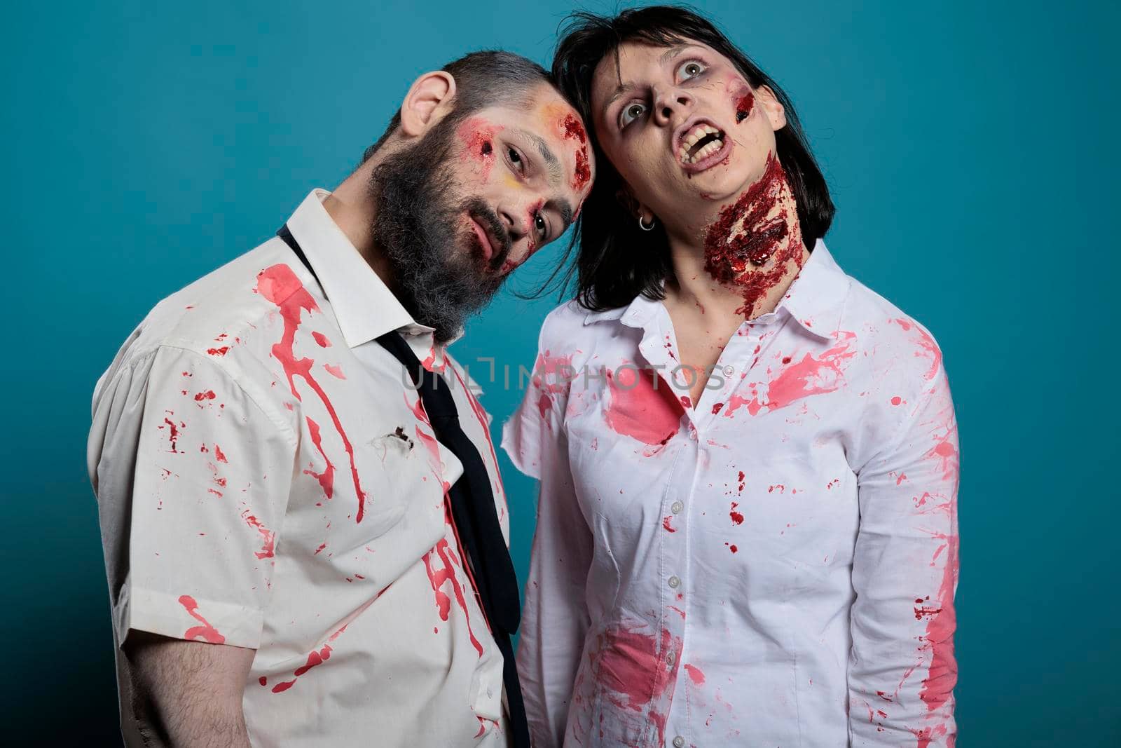 Portrait of zombies couple posing on camera by DCStudio