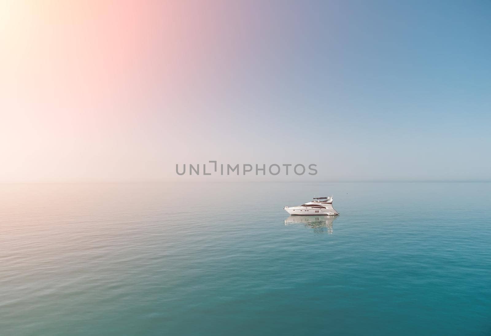 Aerial boat race. Luxury cruise trip. View from above of white boat on deep blue water. Aerial view of rich yacht sailing sea. Motor boat racing wave. Summer journey on luxury ship