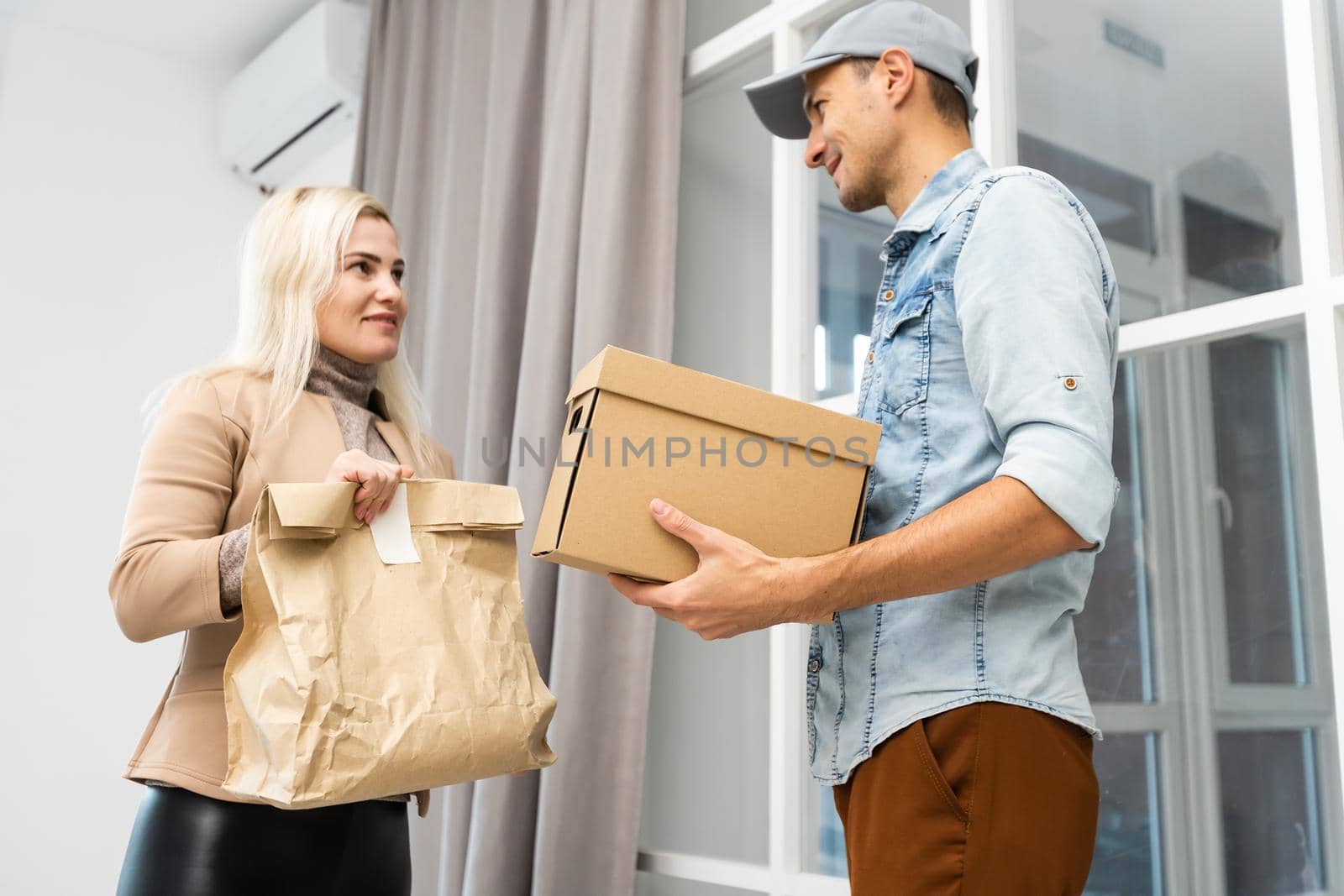 View of a Delivery man handing over a parcel to customer.