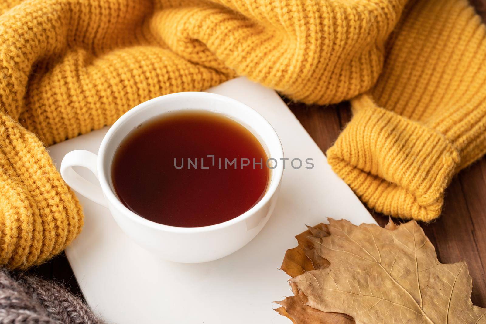 Hello fall. Cozy warm image. Cozy autumn composition, sweater weather. Pumpkins, hot black tea and sweaters